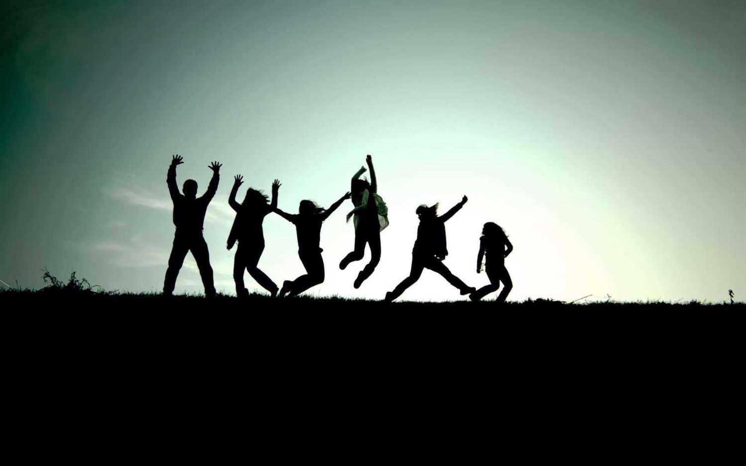 Group of friends jumping up in the air