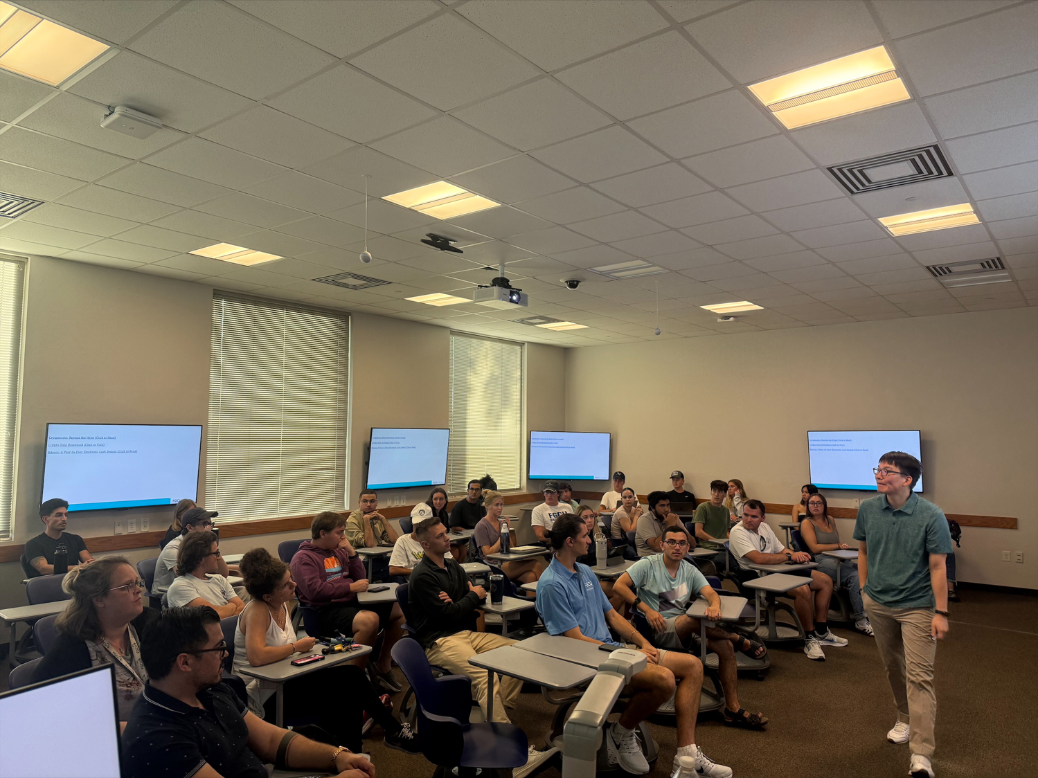 Crypto Club members attentively listening to the guest speaker during an insightful presentation on cryptocurrency and blockchain technology.